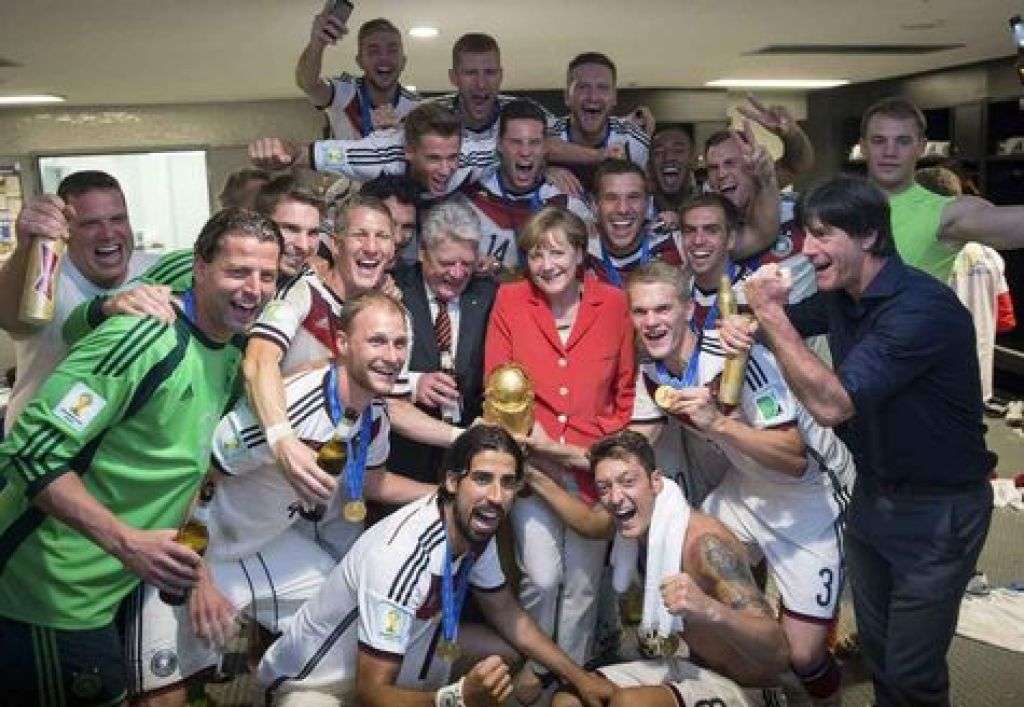 German Chancellor Merkel and German President Gauck pose with the Germany's coach Loew and his players after Germany beat Argentina in the 2014 World Cup final at the Maracana stadium in Rio de Janeiro